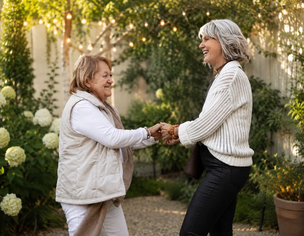 Ros Banksia-Smith holding a guest's hands in a warm welcome outdoors